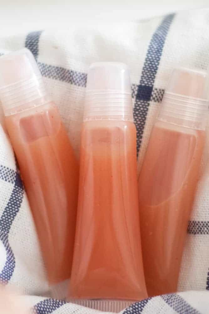 diy lip gloss on white and blue towel