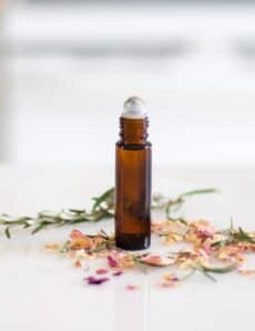 essential oil roller bottle on white marble