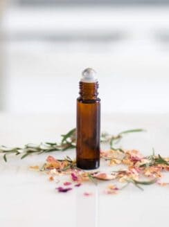 essential oil roller bottle on white marble