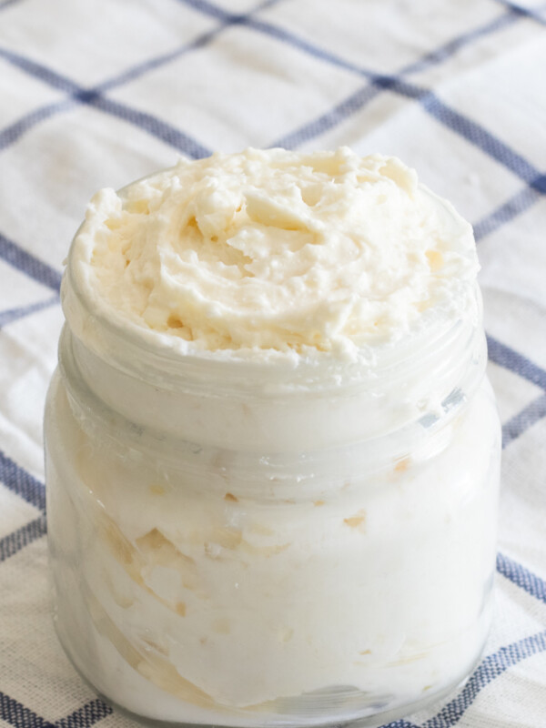 shea butter whipped body butter in glass mason jar on blue and white checker towel