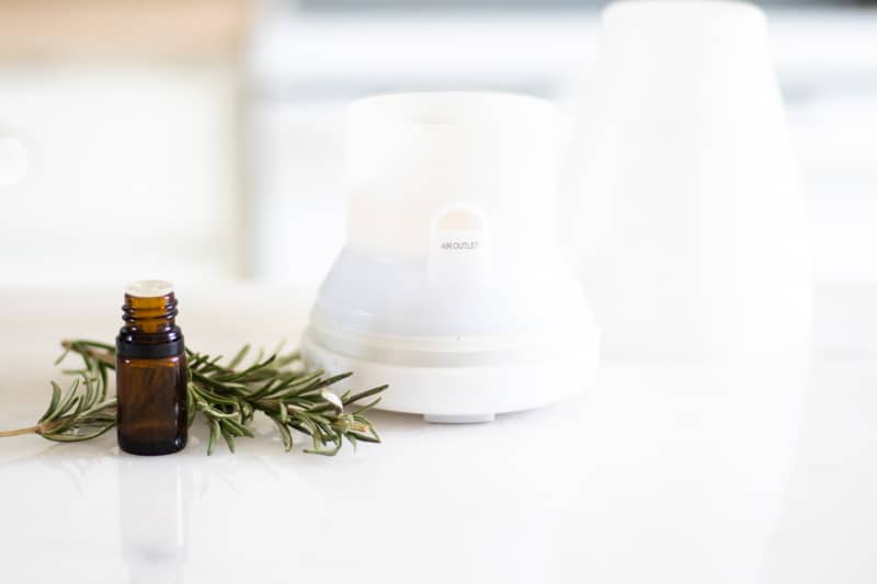 rosemary essential oil bottle and white diffuser