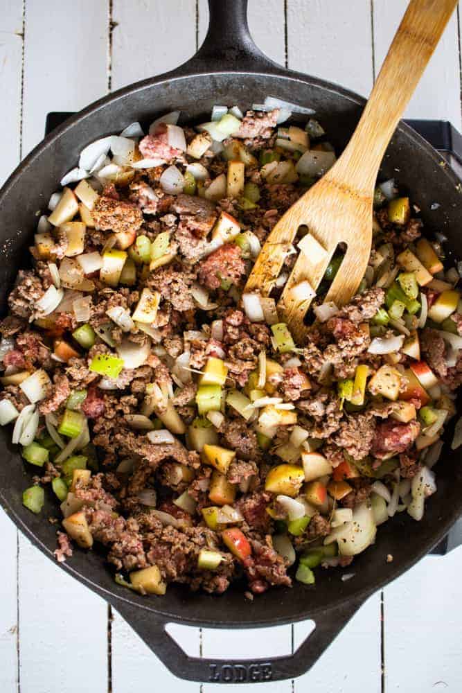 cast iron skillet of ground sausage and vegetables