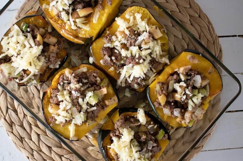 stuffed acorn squash in glass baking dish