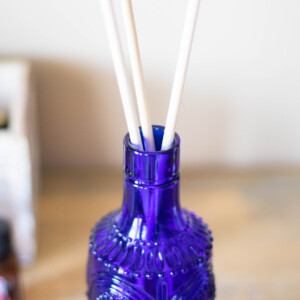 A homemade reed diffuser using a blue vase.