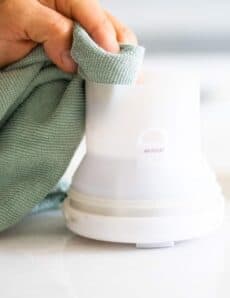 cleaning an essential oil diffuser with microfiber cloth