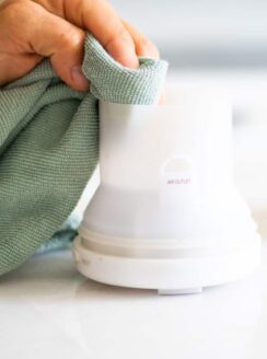 cleaning an essential oil diffuser with microfiber cloth