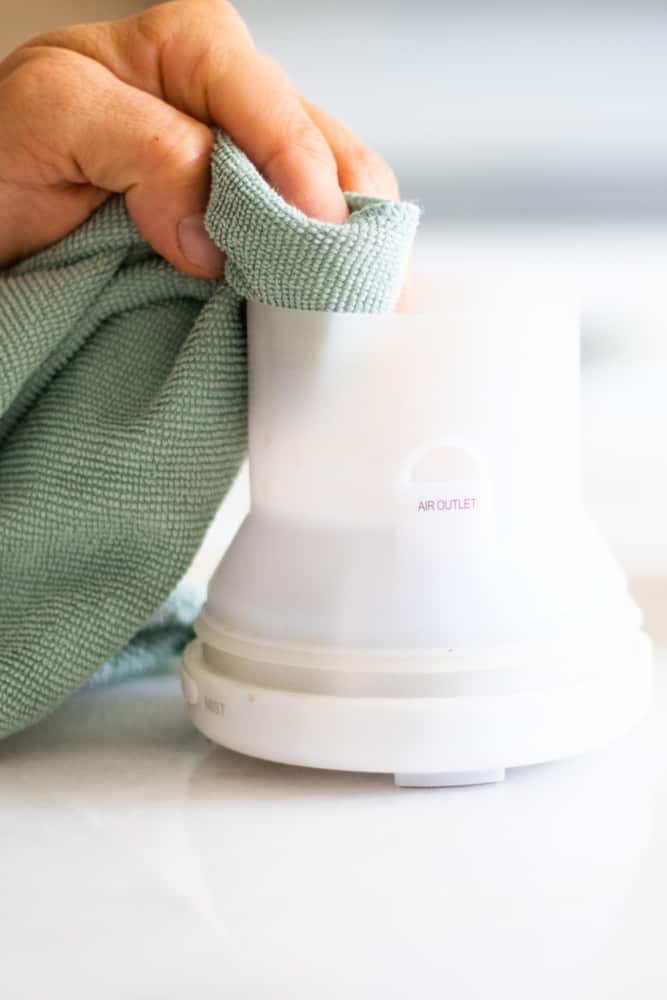 cleaning an essential oil diffuser with microfiber cloth