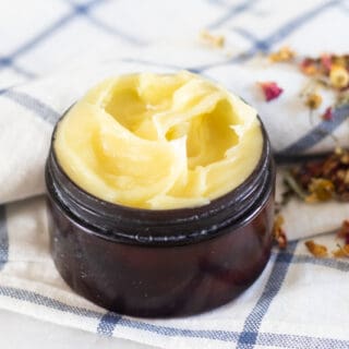 anti-aging face cream in small amber container