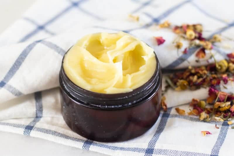 homemade anti-aging face cream in small amber container 