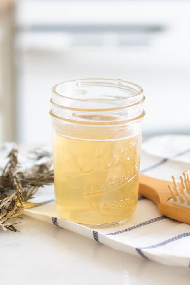 Apple cider vinegar hair rinse in a glass jar.