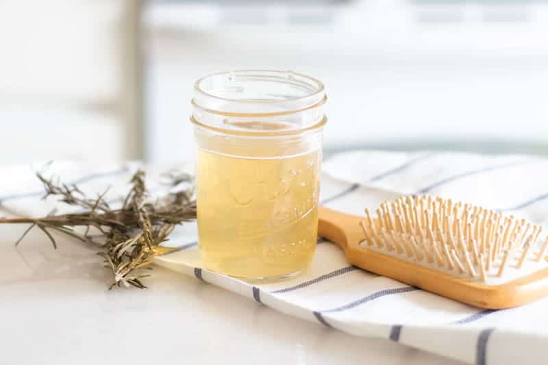 Apple cider hair rinse in a mason jar ready to pour on top of the hair.