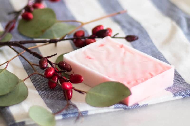 Red homemade Christmas soap bar with eucalyptus and cranberries.