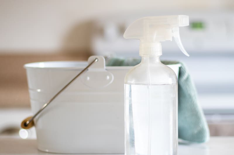 homemade daily shower cleaner and white pail.