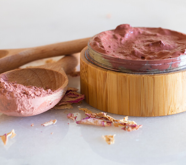 Rose clay face mask in wooden container.