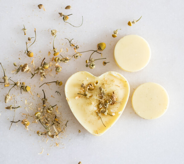 beeswax scented sachet on white marble with dried flowers