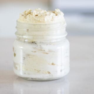 mason jar with homemade whipped body butter on white marble table