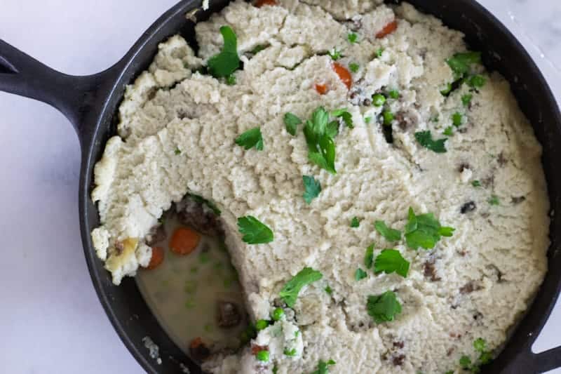 whole30 shepherd's pie in cast iron skillet with fresh rosemary