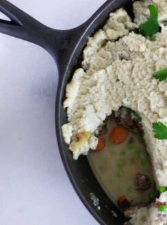 shepherds pie with cauliflower mashed potatoes in cast iron skillet.