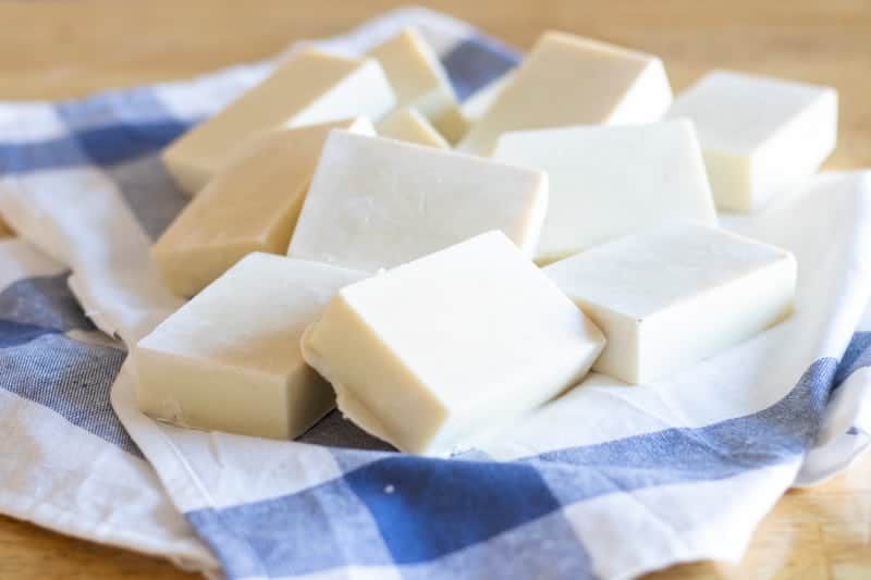 homemade cold-pressed soaps on white and blue tea towel