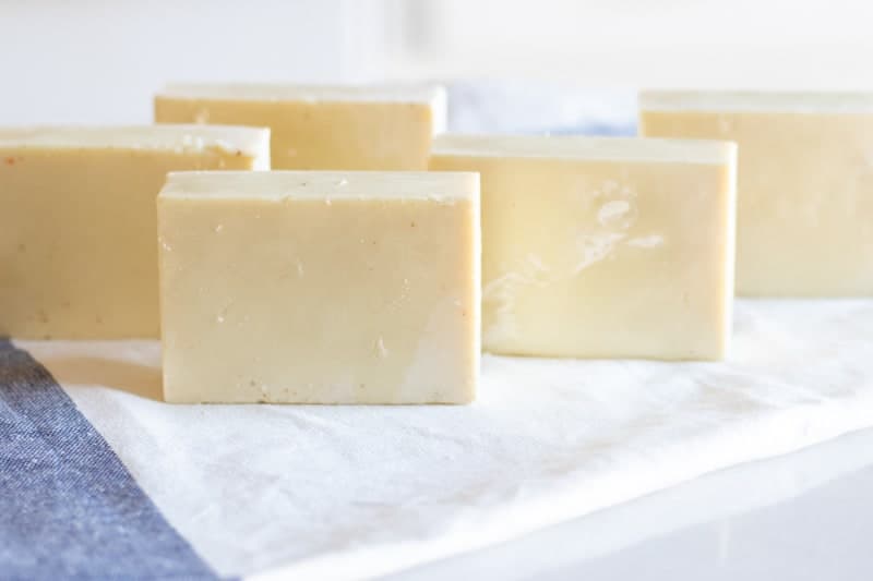 homemade soap bars standing on sides on white and blue towel