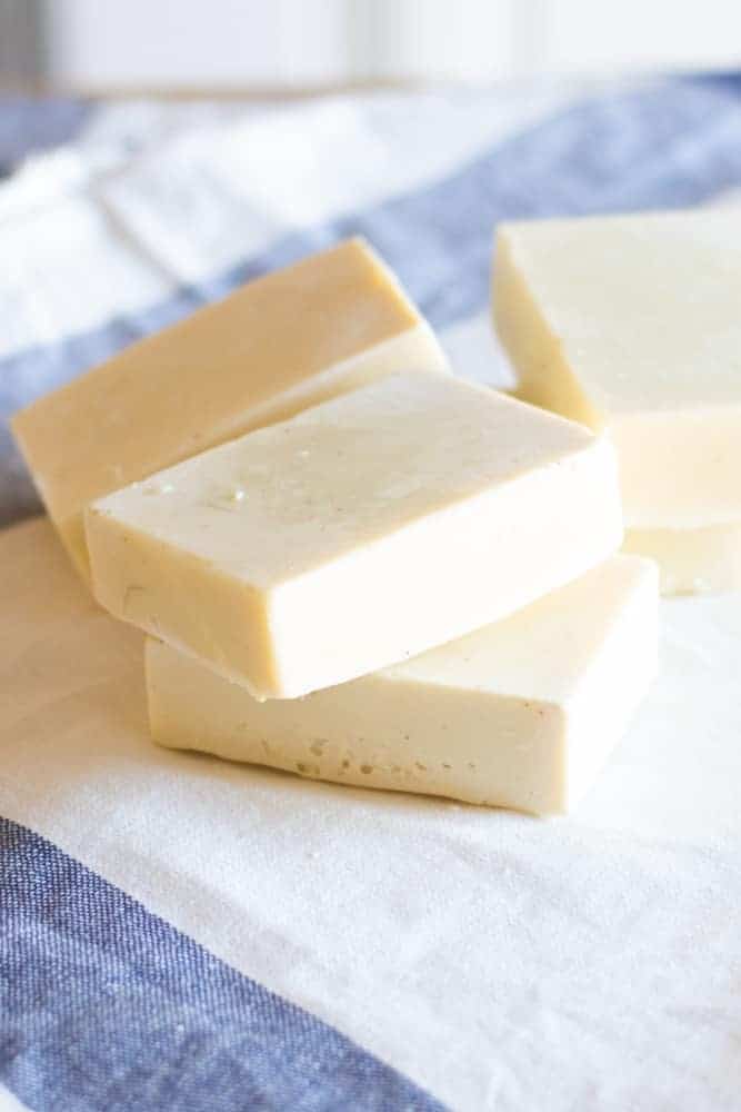 homemade cold-pressed soap on white and blue towel 