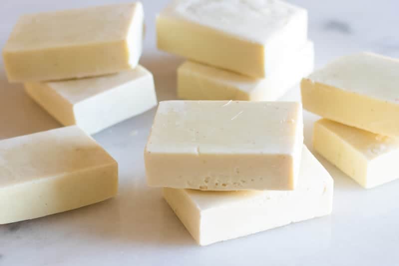 cold-pressed soap bars on white marble table