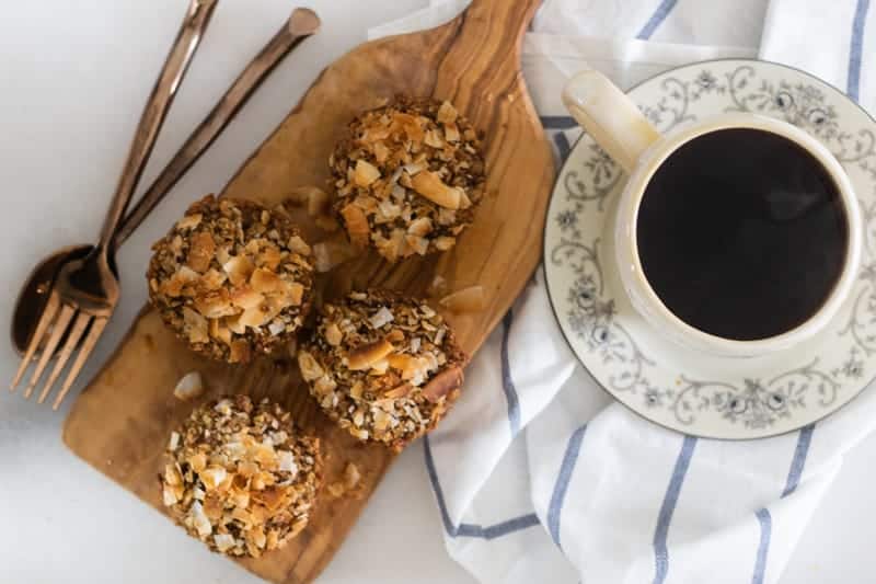 homemade applesauce muffins sprinkled with toasted coconut and a cup of coffee.