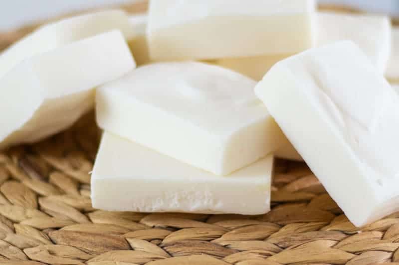 Tallow soap bars stacked on wicker placemat.