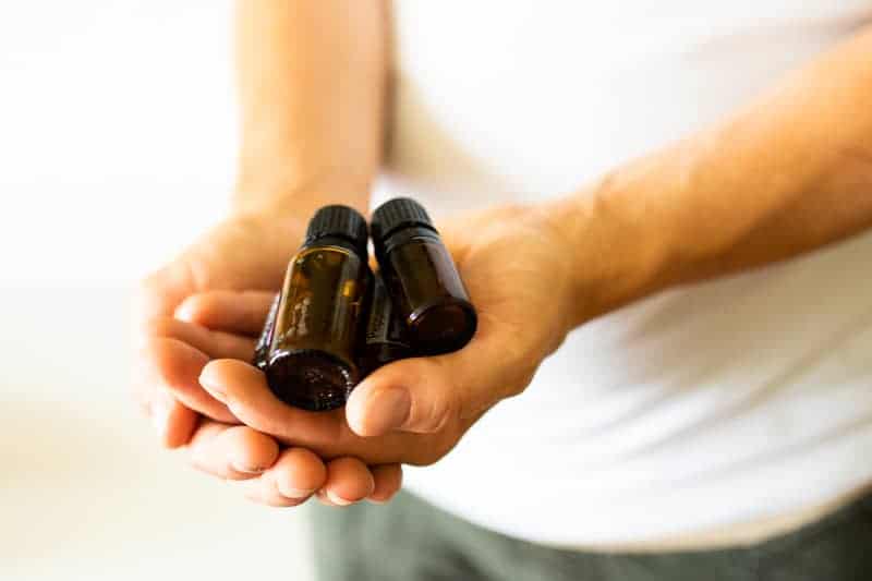 hand holding essential oil bottles