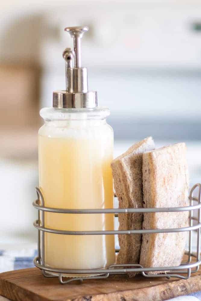 gel homemade dish soap in silver caddy with tan sponges 