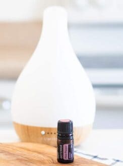 pink pepper essential oil infront of a diffuser.