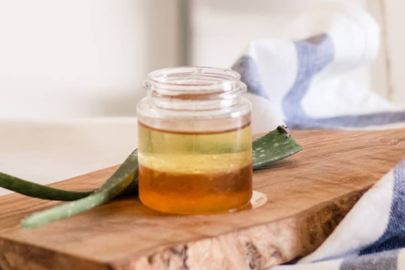 Aloe and honey hair mask on wooden board. 