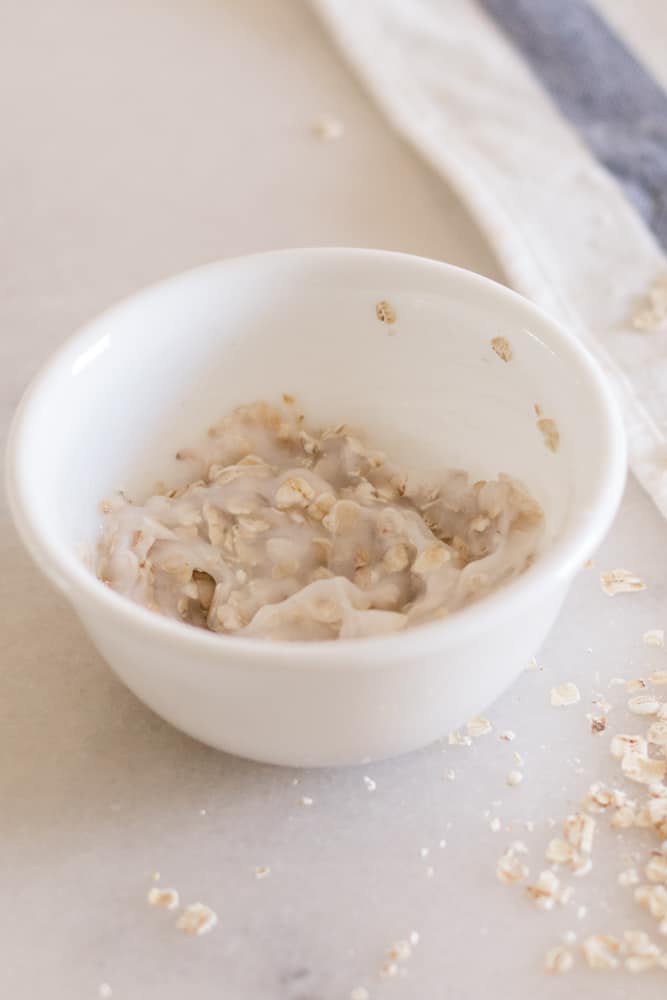 Homemade oatmeal scalp scrub in white bowl.