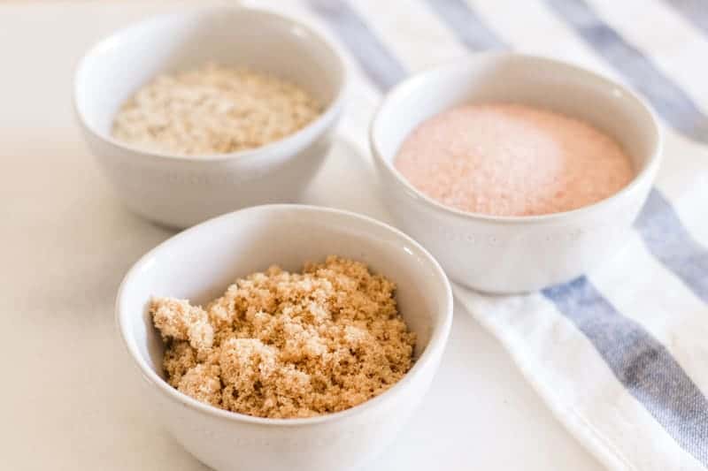 Different scalp exfoliators in small individual bowls.