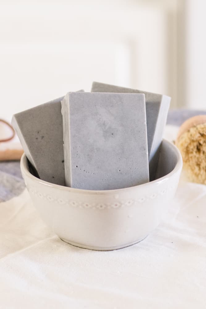 Charcoal melt and pour soap bars in white bowl. 