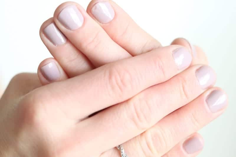 Women's hands with pink fingernail polish. 