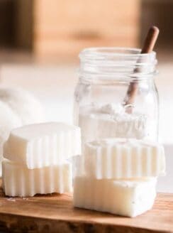 Homemade laundry soap bars on wooden board.