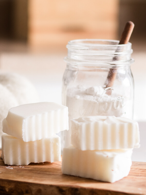 Homemade laundry soap bars on wooden board.