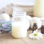 Homemade laundry soap in a glass mason jar with lavender springs.