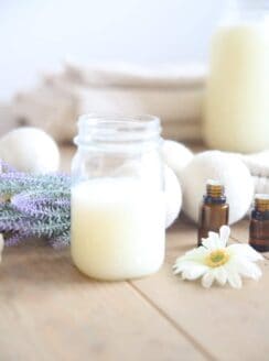 Homemade laundry soap in a glass mason jar with lavender springs.