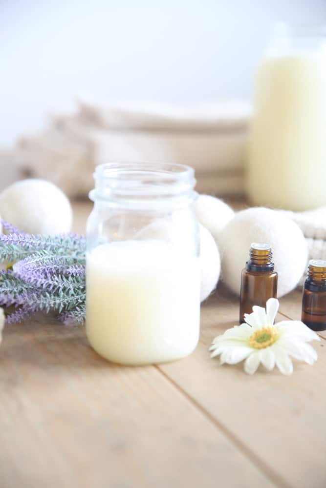 Homemade laundry soap in a glass mason jar with lavender springs.