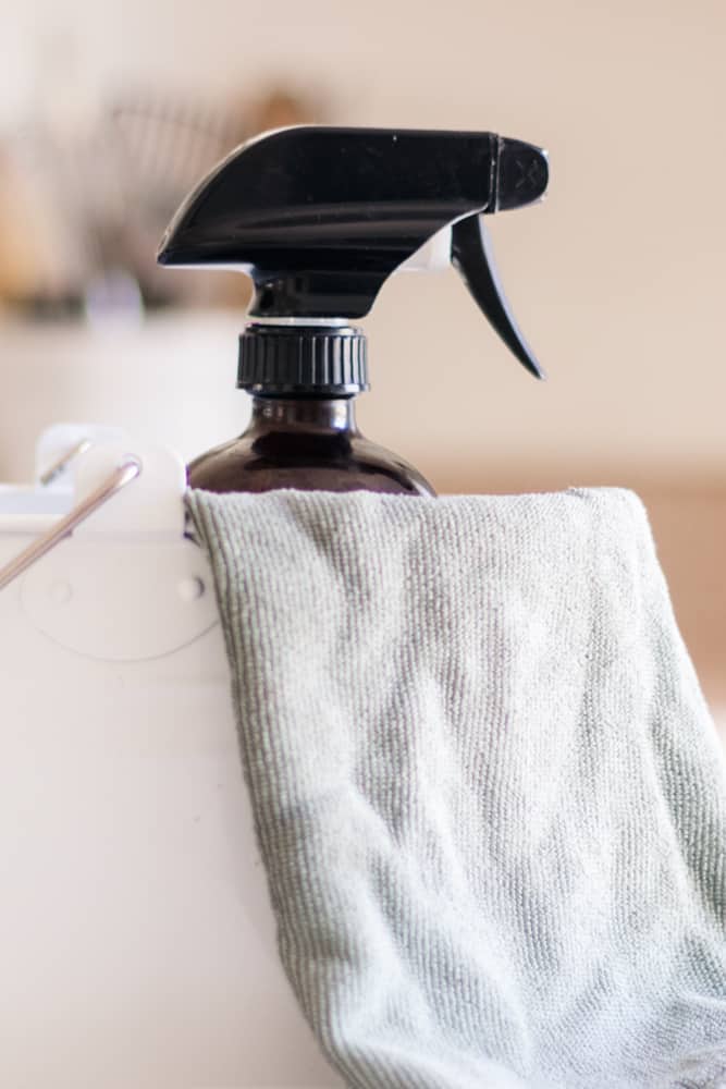 Cleaning caddy with dusting spray and microfiber cloth in it.