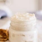 Homemade hand cream in a small glass jar.