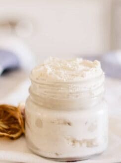 Homemade hand cream in a small glass jar.