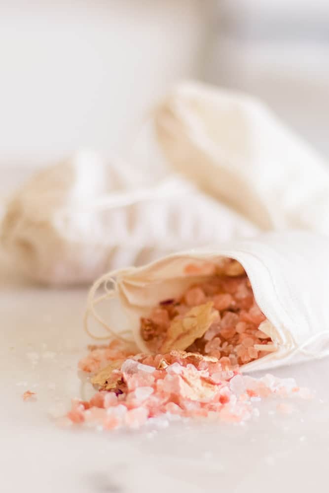 Homemade bath salts in white muslin bag.