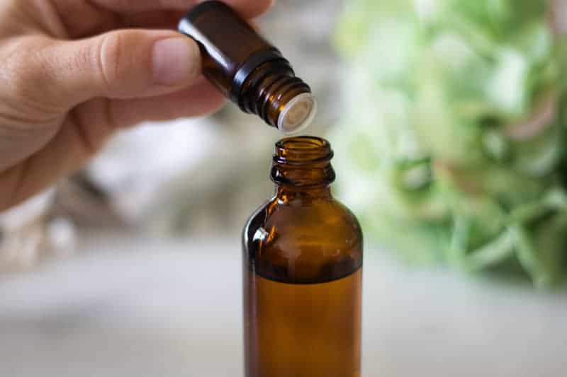 Adding essential oils to a homemade mattress spray.