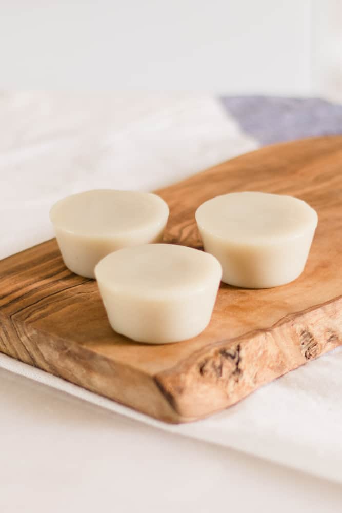 Lotion bars sitting on a wooden tray.