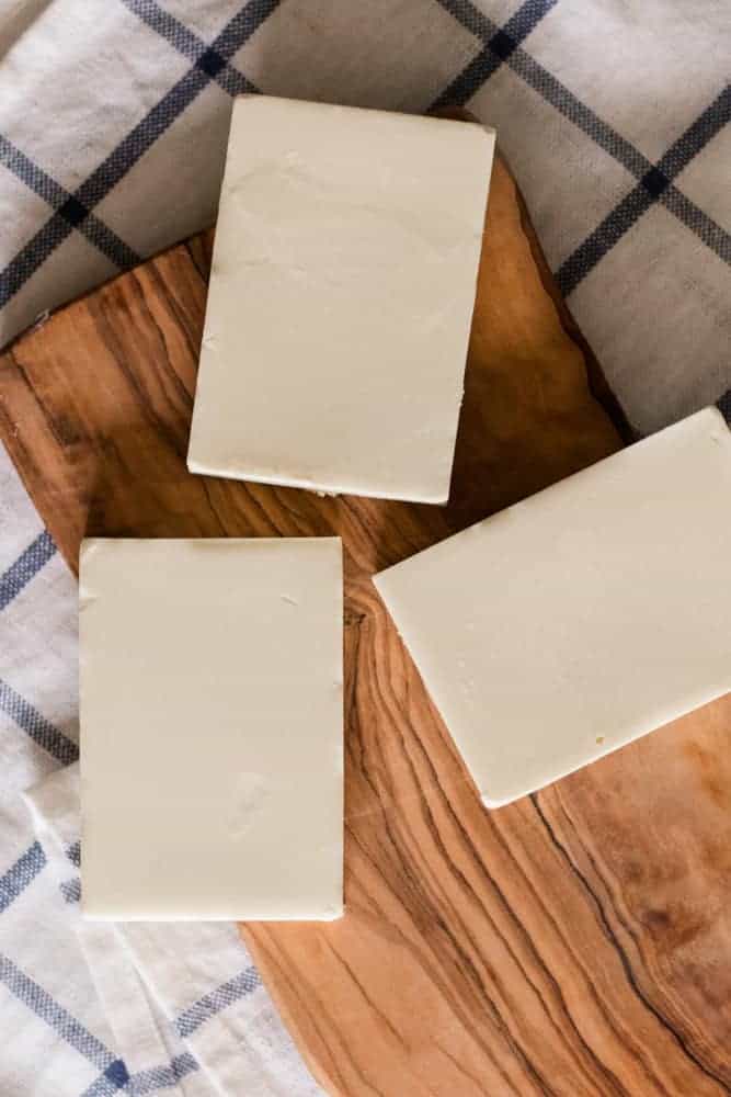 Homemade sunscreen bars on wooden board. 