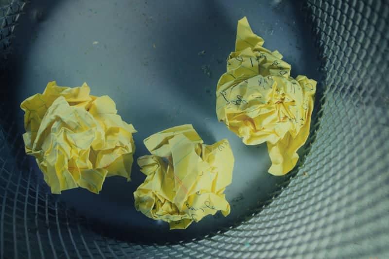 Yellow paper in metal trashcan. 