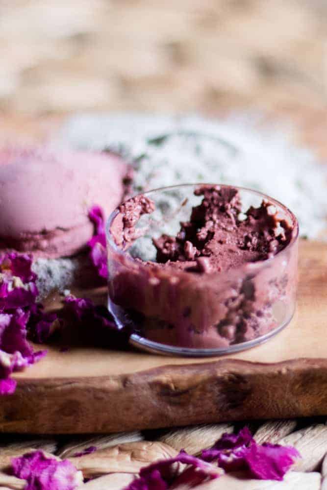 Pink clay face mask in small clear container.